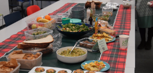 table laid out with colourful vegan foods, in bowls with a long table runner
